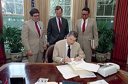 US President Ronald Reagan signing a veto of a bill
