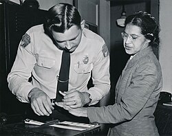 Rosa Parks being fingerprinted after being arrested for not giving up her seat on a bus to a white person.
