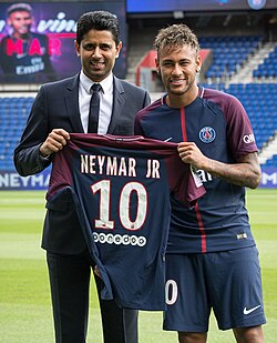 Neymar posing with his PSG number 10 jersey alongside club president Nasser Al-Khelaifi