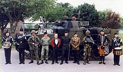 Royal Irish Rangers: soldiers and officers in Numbers 8, 14, 10, 1, 2 and 12 orders of dress, flanked by a bandsman, bugler, piper and drummer in versions of (rifles) full-dress.