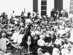 Mahatma Gandhi (seated in carriage, on the right, eyes downcast, with black flat-top hat) receiving a big welcome in Karachi in 1916 after his return to India from South Africa