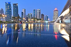 A view of a water feature in Sheraton Park with the West Bay skyline in the background