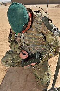 Soldiers of 24 Commando (Engineer) Regiment wear the Royal Engineer cap badge on a green Commando beret.