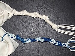 Blue and white tzitzit knotted in the Sephardi style, the all white is Ashkenazi.