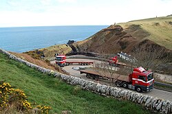 Articulated trucks negotiating the hairpin bends at Berriedale