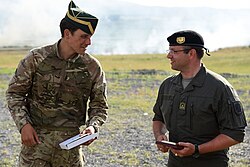 A British officer, left, of the Queen's Royal Hussars wearing a Tent Hat with No. 8 dress.