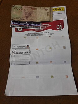 An election leaflet with money stapled to it