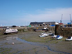 Low tide view of St Julian's Pier and Cambridge Berth