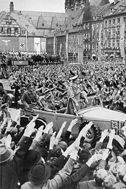 Adolf Hitler being welcomed by a crowd in Sudetenland, where the pro-Nazi Sudeten German Party gained 88% of ethnic-German votes in May 1938[91]