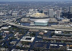 An aerial view of flooded areas of Central City and Central Business District, with the New Orleans Arena and the damaged Louisiana Superdome at center.