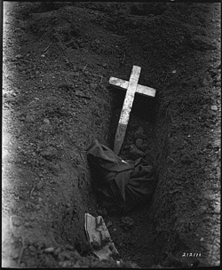 U.S. Army personnel identified the charred remains of the Americans captured at Bataan and Corregidor and burned alive on Palawan, 20 March 1945.