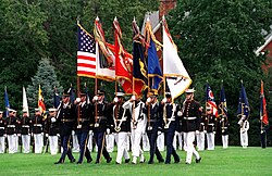 Joint colour guard showing the organizational colours of each branch (L-R): National, Army, Marine Corps, Navy, Air Force, and Coast Guard.