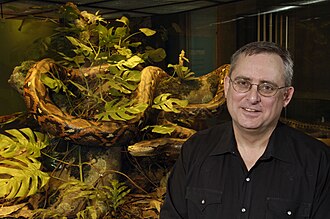Frost next to diorama of a reticulated python.
