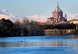 Ticino downstream from the city, in the background, behind the dome of the cathedral, the Monte Rosa