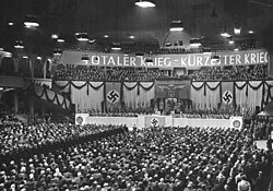 Nazi rally on 18 February 1943 at the Berlin Sportpalast; the sign says "Totaler Krieg – Kürzester Krieg" ("Total War – Shortest War")