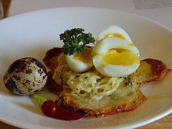Soft-boiled quail eggs with potato galettes. The yolk of the eggs have not yet fully solidified.