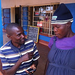 An enumerator conducting a census survey using a mobile phone-based questionnaire in the rural Mutasa District in Zimbabwe in 2015