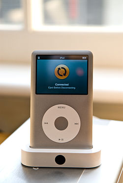 A docked iPod Classic; Apple worked with other manufacturers to implement purpose-built "Made for iPod" docking stations.