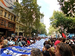 Flag with images of those who disappeared during a demonstration in Buenos Aires to commemorate the 40th anniversary of the 1976 coup in Argentina