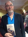Darach Ó Scolaí at Oireachtas na Gaeilge 2015, with the book Oileán an Órchiste his translation and adaptation of the famous book Treasure Island by Robert Louis Stevenson