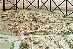 Model of archaic Rome. The image faces northeast, with the Capitoline hill on left and the Palatine on right. The city would not have looked like this prior to the seventh century BC.