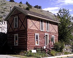 A variation of the second meaning of half-timbered: the ground floor is log and the upper floor is framed (half-timbered in the first sense). Kluge House, Montana, U.S.