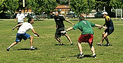 An offensive player tries to play through a three-person cup defense during an informal game.