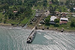 Landing ships move supplies onshore from the rescue fleet.