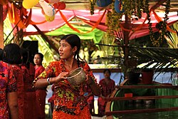 An Arakan (Rakhine) girl pours water at travellers during the Burmese New Year Thingyan Water Festival in Yangon.