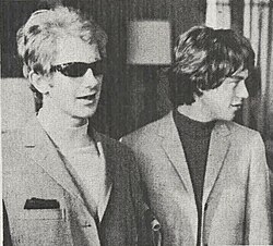 Andrew Loog Oldham (left) with Mick Jagger in 1966. Oldham popularized the term "wall of sound" to describe Spector's production style, which Oldham imitated on records produced for the Rolling Stones.