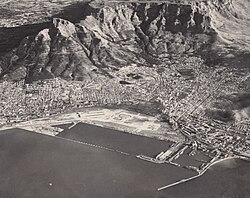 An aerial photograph of the newly completed Cape Town foreshore in 1945. Visible in this photograph as the large area of empty land between the City Centre and the newly constructed harbour out of reclaimed land from Table Bay.[40]