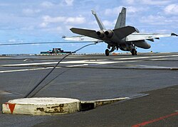 An F/A-18 makes an arrested landing