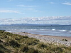 View from Findhorn: The hills across inner Moray Firth end in Tarbat Ness. The mountains in the background rise behind Dornoch Firth.