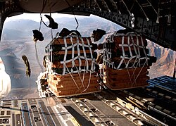 Pallets of supplies being dropped to servicemembers at a remote camp in Afghanistan. Air transport was an important part of NATO logistics in Afghanistan.