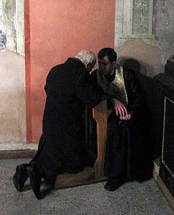 A penitent confessing his sins
