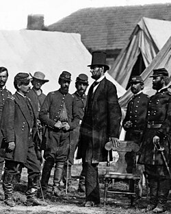 President Abraham Lincoln successfully preserved the Union during the American Civil War. Here he is (center) with General George B. McClellan (left), and soldiers at Antietam, on October 3, 1862.