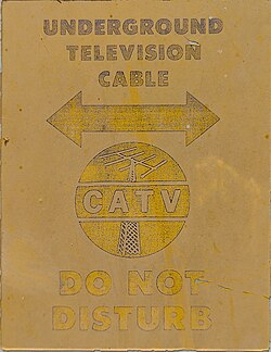 A sign warning about a buried CATV cable in the area