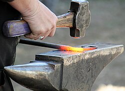 An incandescent steel workpiece in a blacksmith's art