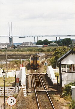 British Rail Class 156 on a Far North Line service crossing over the canal on the Clachnaharry Swing Bridge. The bridge in the background is the Kessock Bridge.