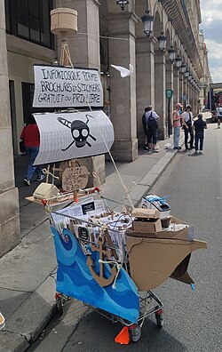 Brochures and stickers being offered for free or "prix libre" (pay what you want) in Paris