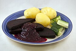 Blodpudding served with boiled potatoes, cucumbers and lingonberry jam