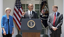 President Obama (center) nominating Richard Cordray (right) as the first director of the CFPB. Elizabeth Warren (left) conceived of the CFPB and was both its inaugural interim director and special advisor
