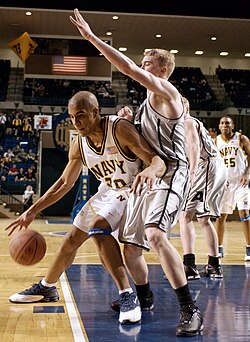 A U.S. Naval Academy ("Navy") player, left, posts up a U.S. Military Academy ("Army") defender.