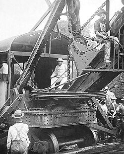 US President Theodore Roosevelt sitting on a steam shovel at the Panama Canal, 1906