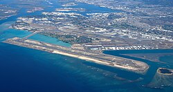 Aerial view of the Daniel K. Inouye International Airport, with Hickam Air Force Base visible in the upper left corner