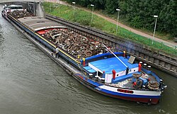 A heavily laden barge in France. Note the bluff bow and the limited freeboard.