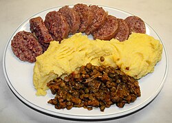 Cotechino, polenta and lentils, traditionally eaten in Italy on New Year's Eve dinner