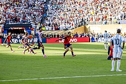 Spain's players celebrating after the final whistle, as Lionel Messi looks on.