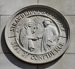 The S&C "Seal of Confidence" (1911-2006), depicting William Penn and a Lenape tribesman shaking hands, their "never written, never broken" treaty; it stood for S&C's Quaker-based tradition of fairness and honesty, which included a money-back guarantee on all merchandise[5]