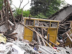A single door frame bearing a portrait of Mao Zedong remained standing in a pile of debris.